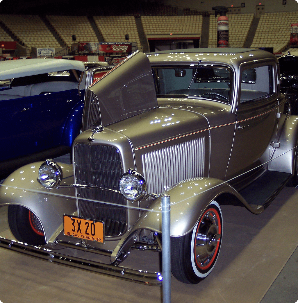 Silver vintage car with hood open display.