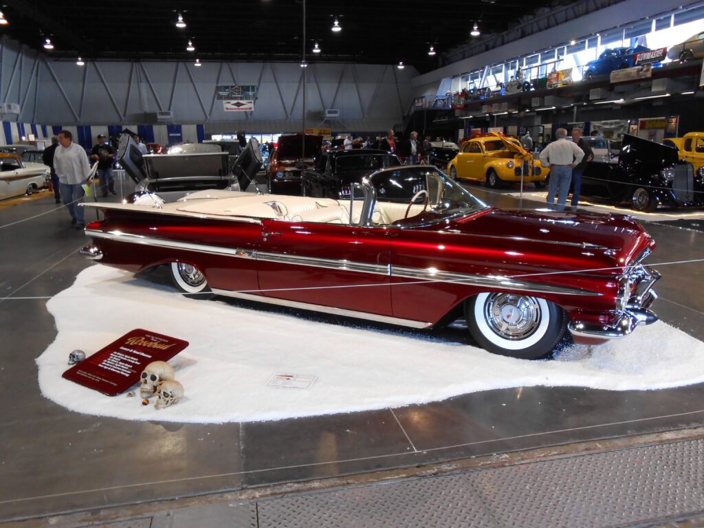Red classic convertible on display at show.