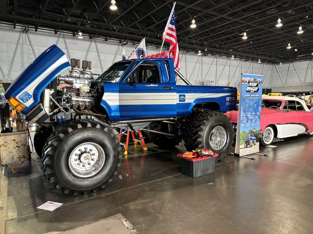 Blue lifted monster truck at car show